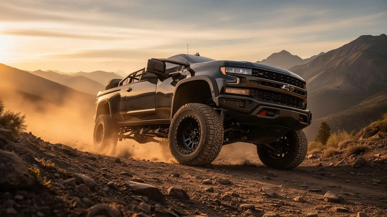 Lifted truck on mountain trail at golden hour